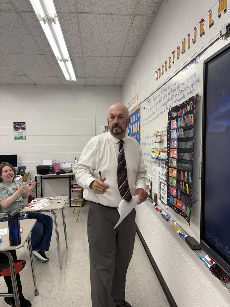 Dr. Witten adding his little person to Mrs. Jan's class feelings chart!