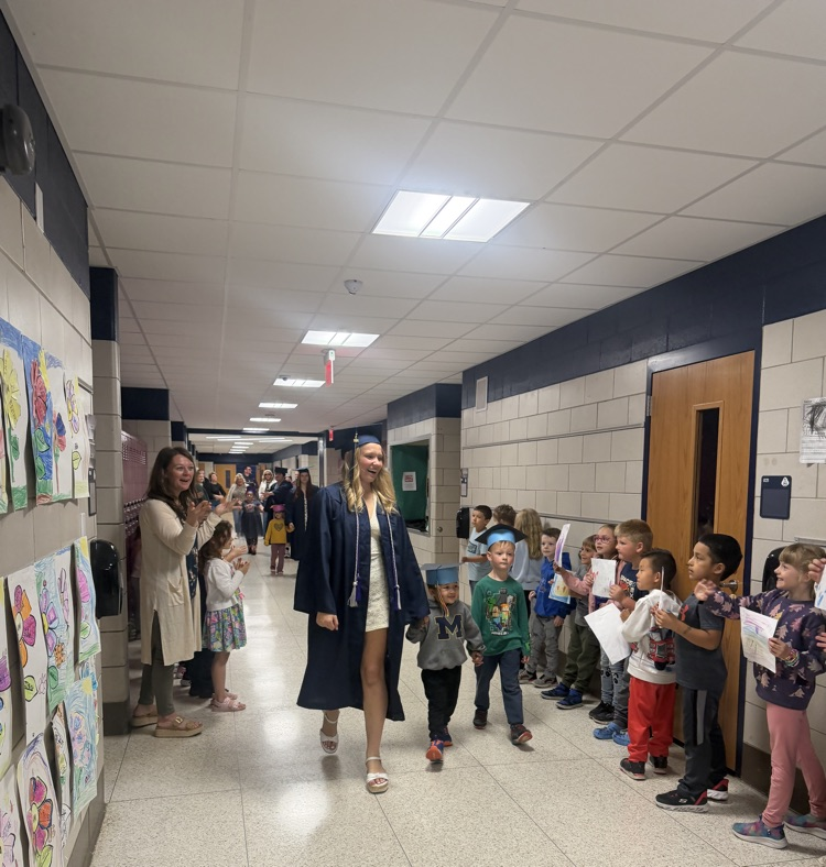 graduate walking hallway