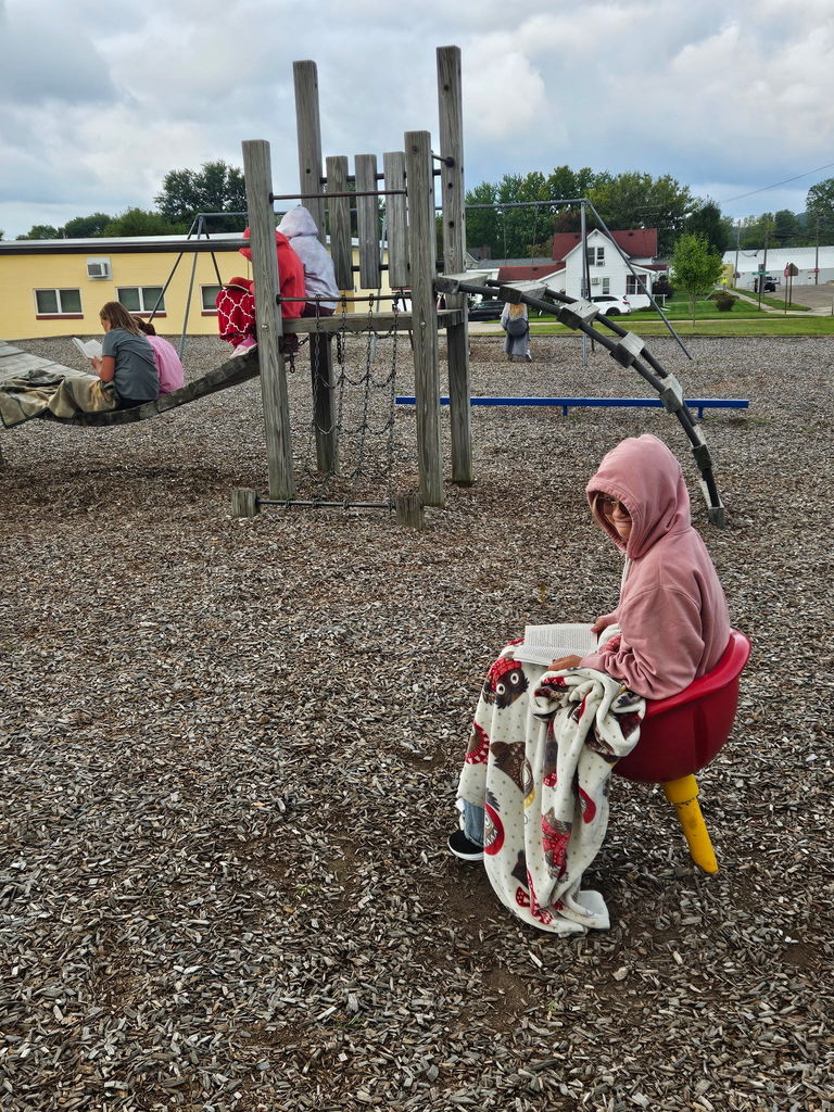 Students reading outside with blankets