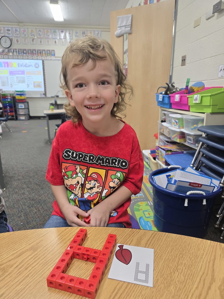 Student with letter A built out of linking blocks