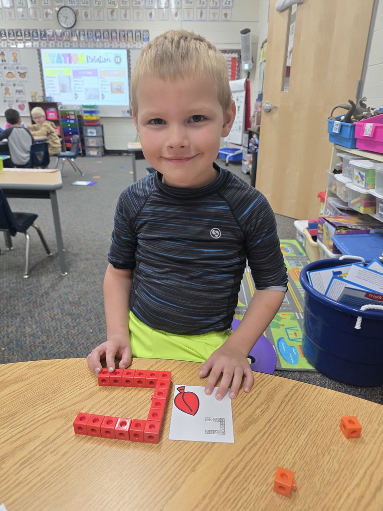 Student with letter C built out of linking blocks