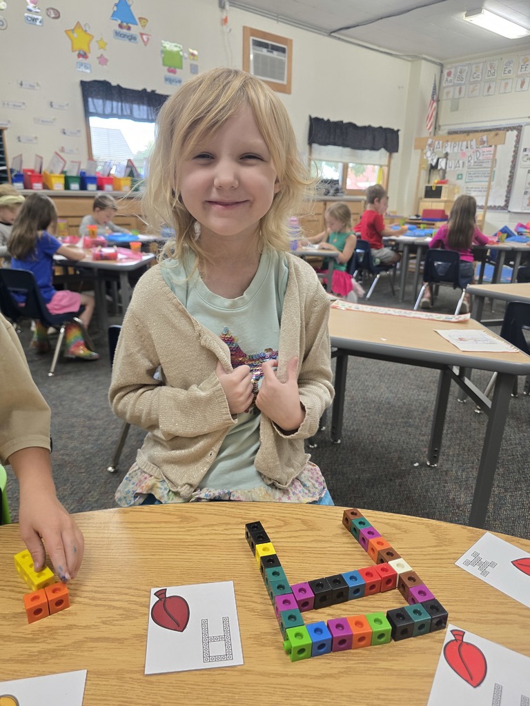 Student with letter A built out of linking blocks