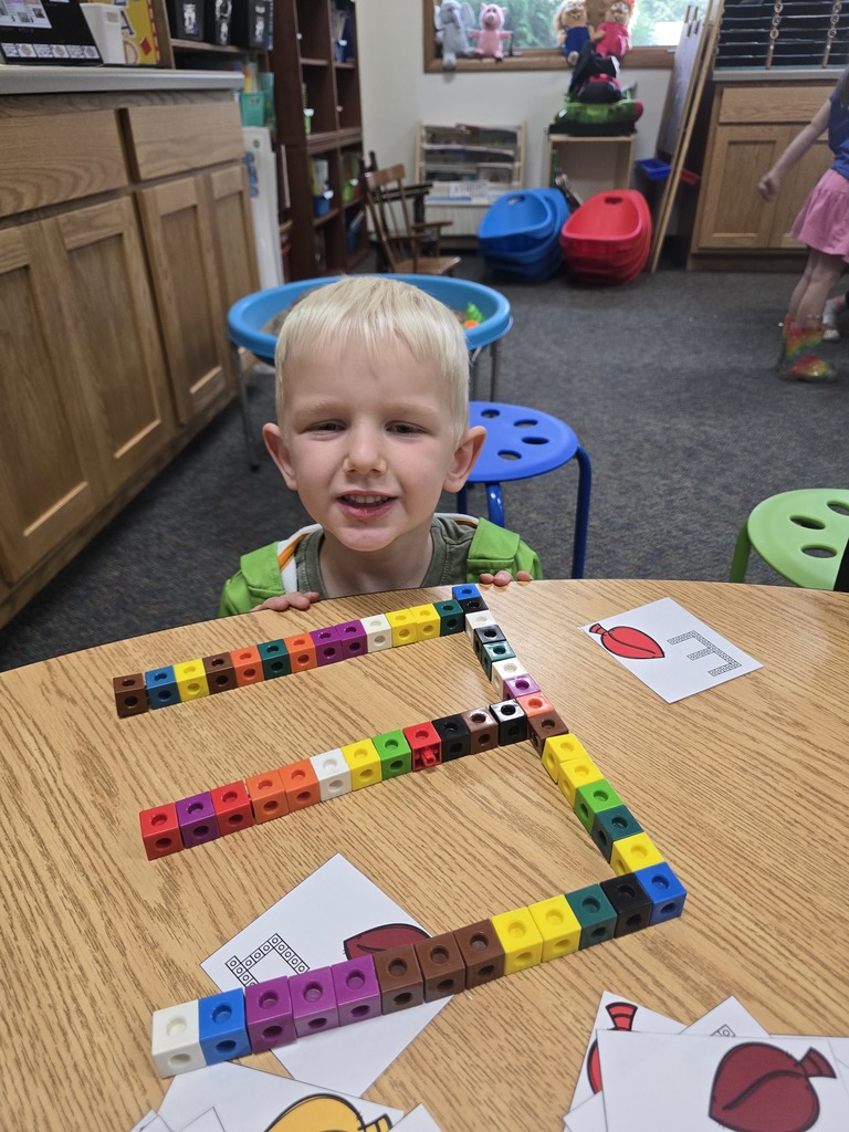 Student with letter E built out of linking blocks