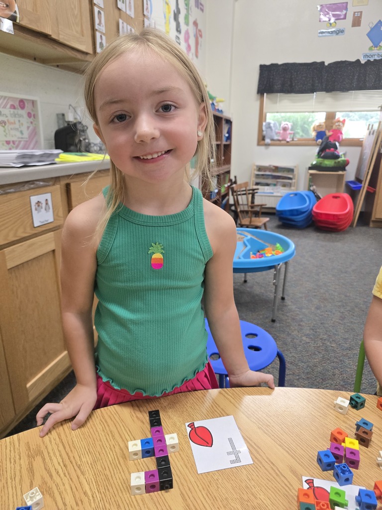 Student with letter F built out of linking blocks
