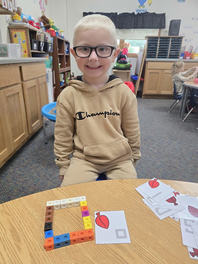 Student with letter O built out of linking blocks