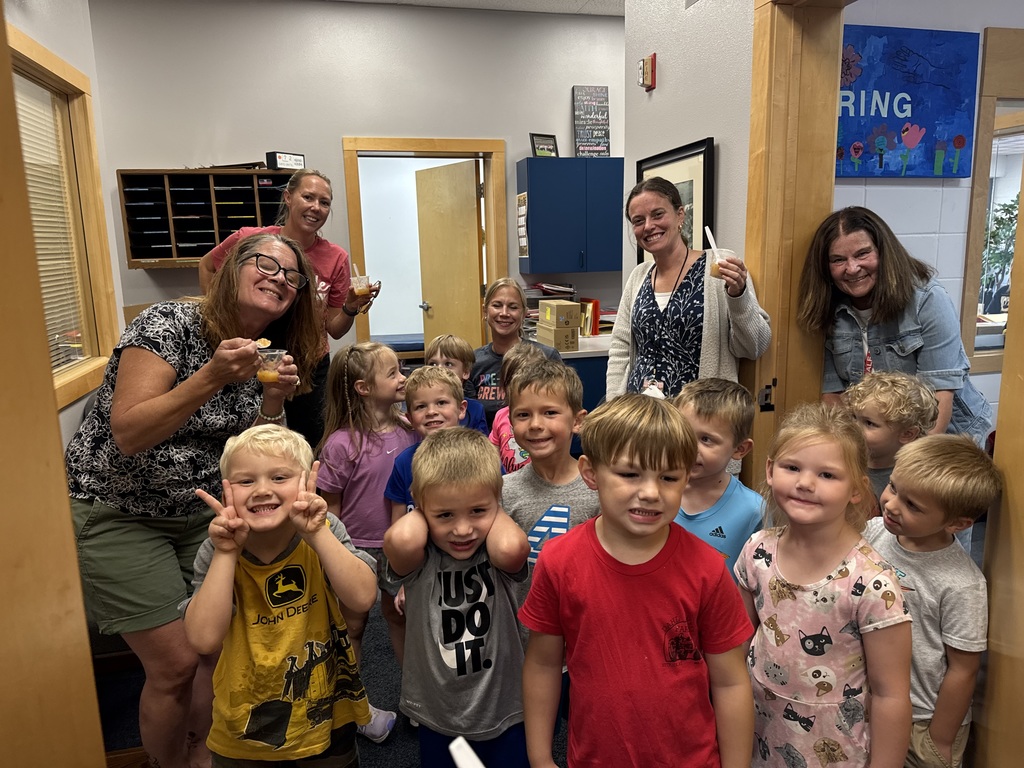 Students sharing apple sauce in the office