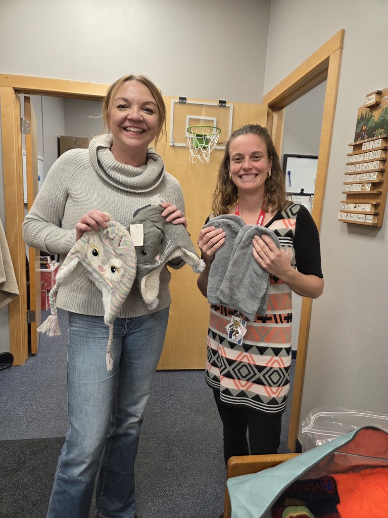 Adults holding hats and mittens