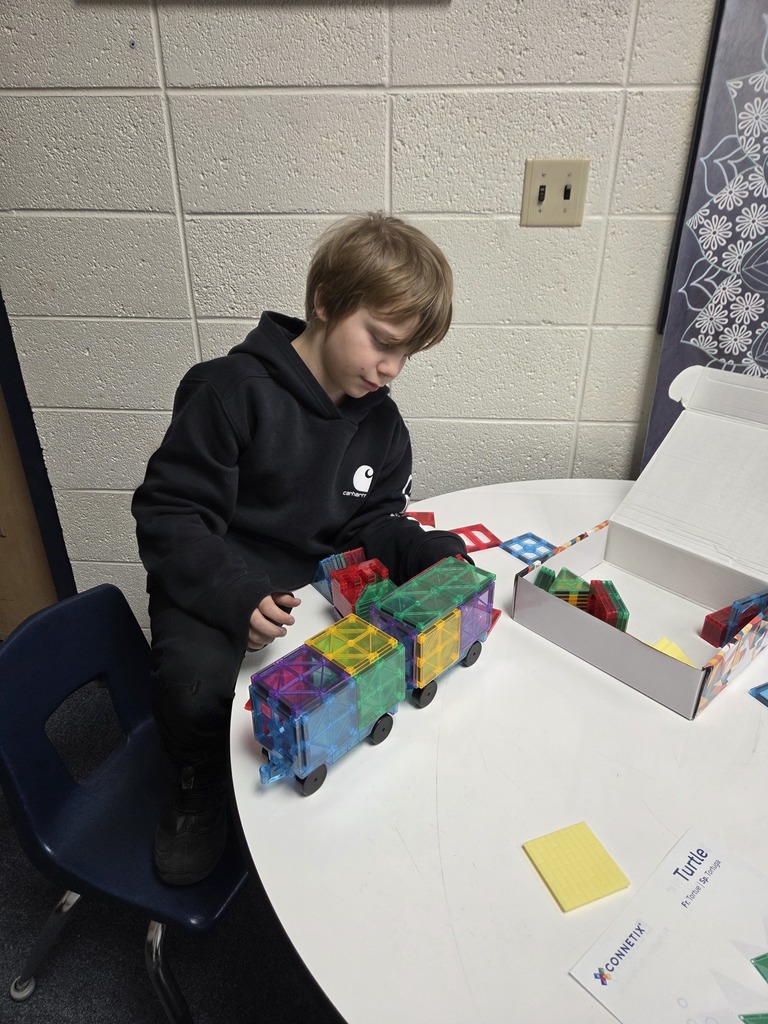 student playing with magnetic tiles