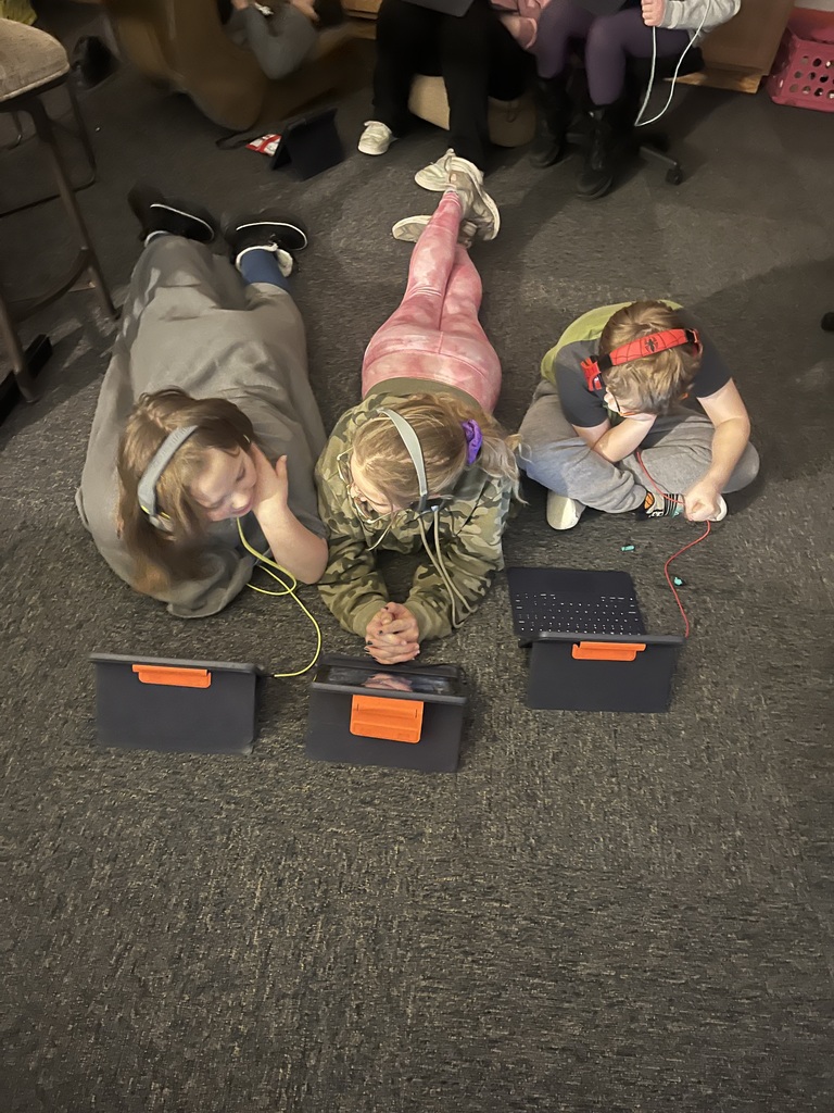 Students listening to podcasts with snacks, drinks, and blankets