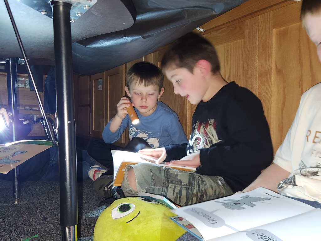 Students flashlight reading under forts