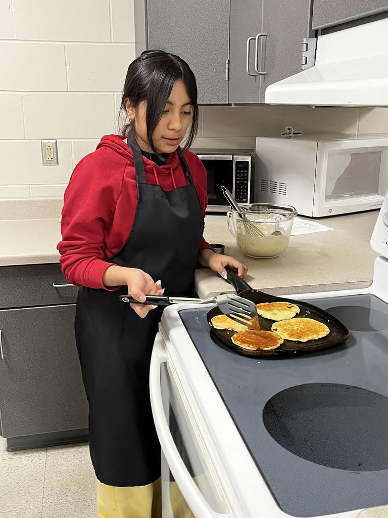 A student waits patiently to flip their pancakes.