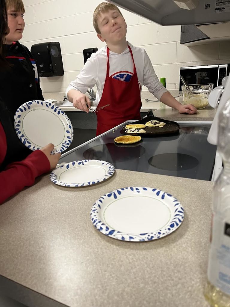 A flipping accident, a students pancake lands on the stove top. 