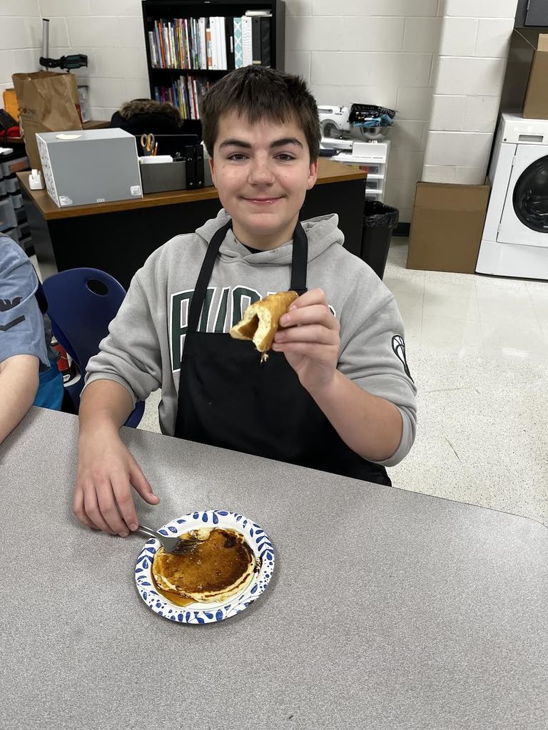 A student shows off their finished pancakes!