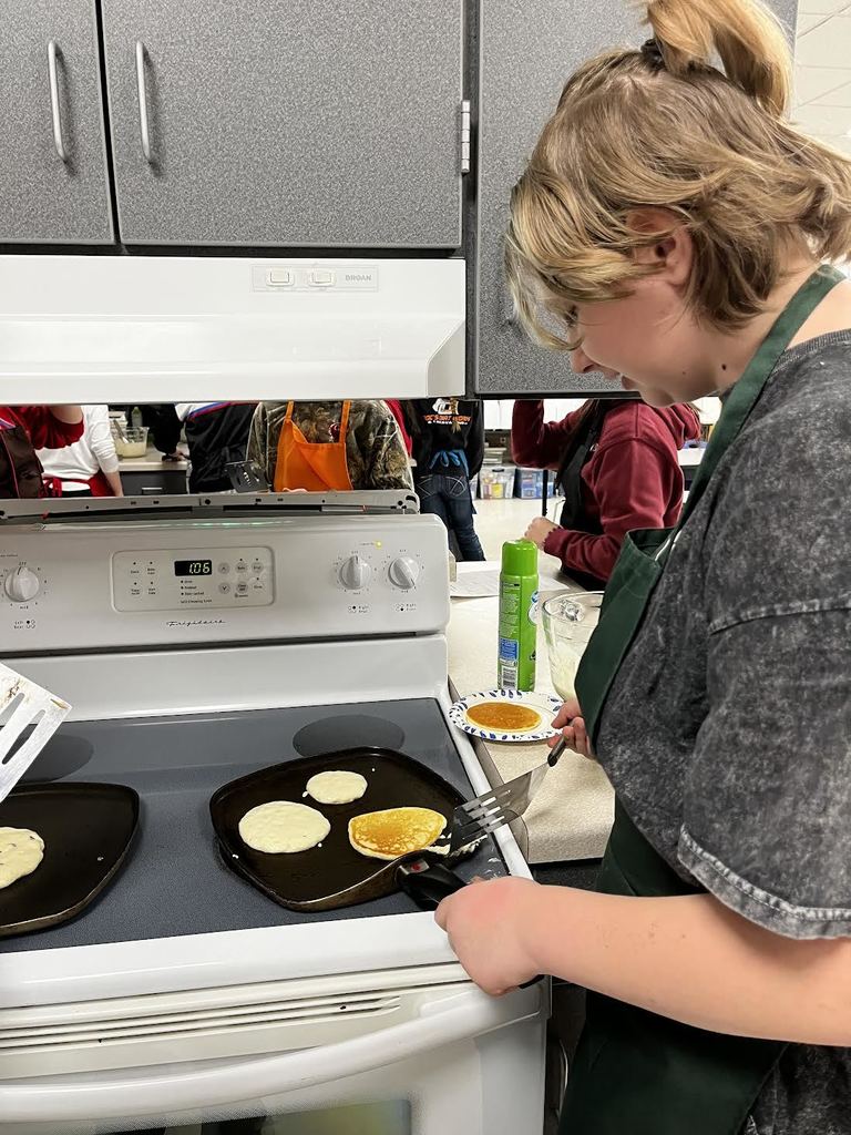 A student waits patiently to flip their pancakes.