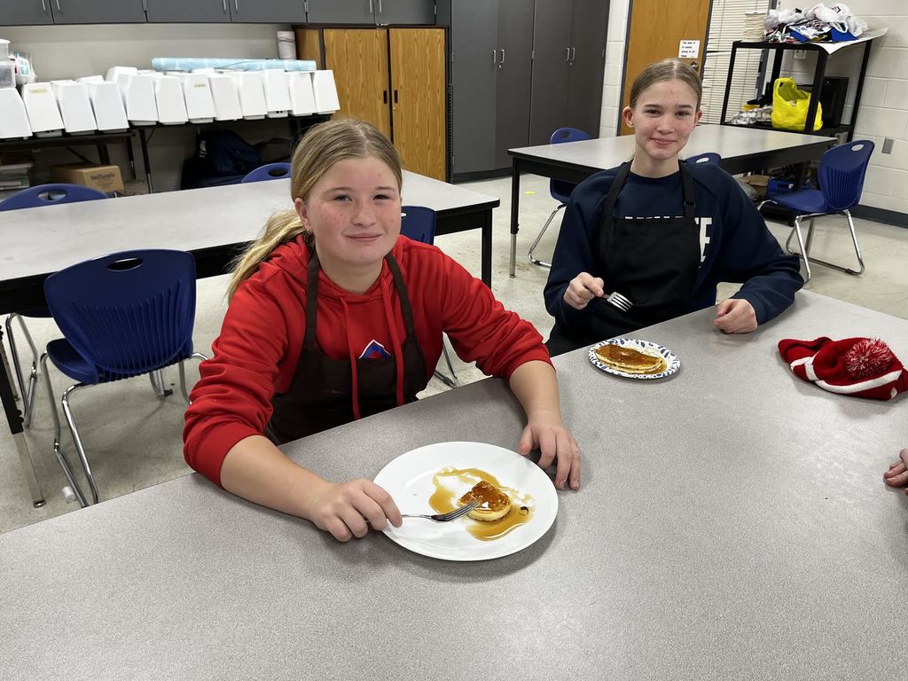 Two students enjoying their pancakes. 