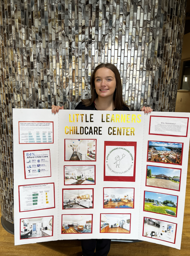 A student showing off their Entrepreneurship project. 