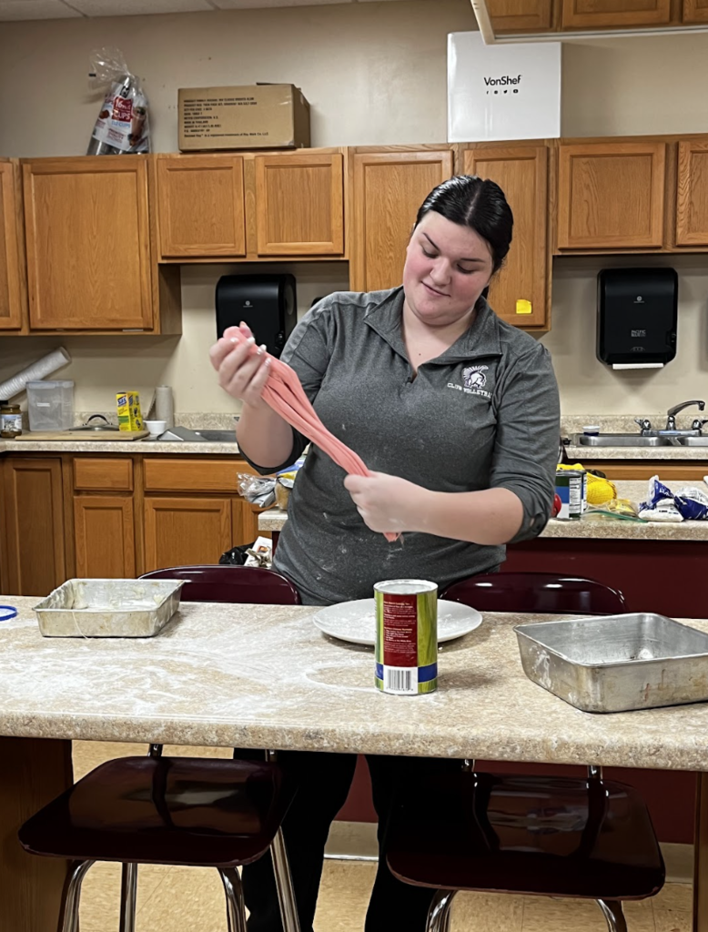 A student pulls their cooled taffy.