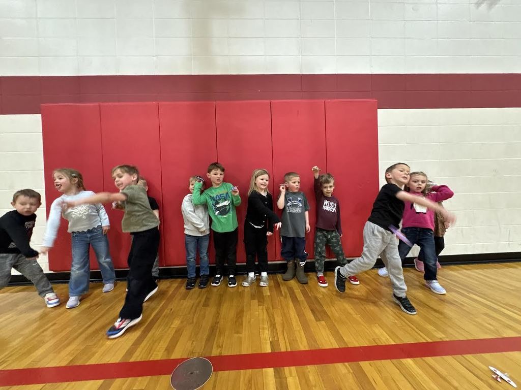 Students participating in a throwing airplane contest