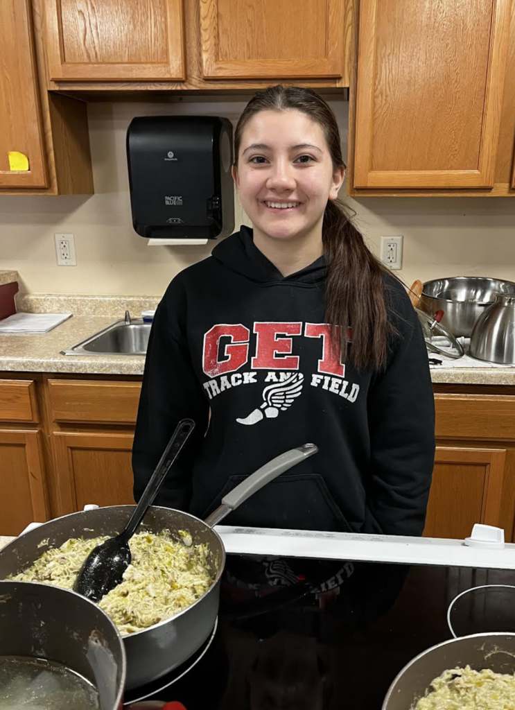 A student in charge of filling and wrapping up the tamales.
