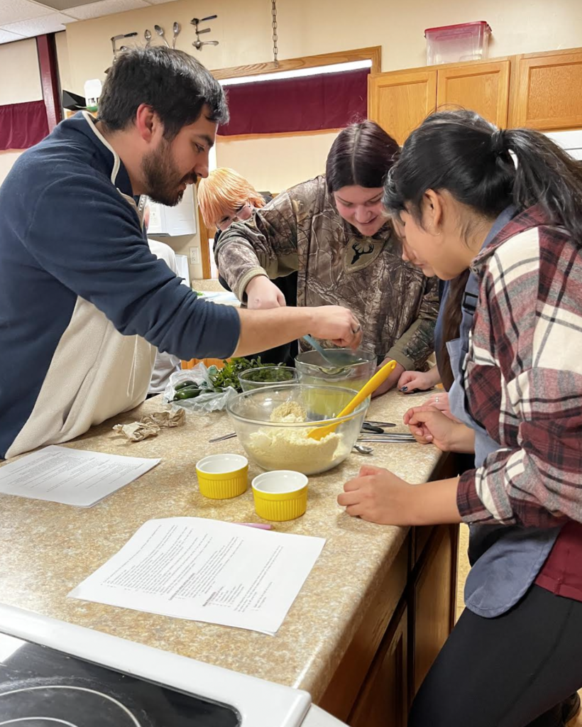 Mr. Mendez shows the class how to make tamales.