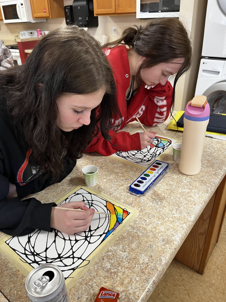 Students using watercolor on their neurographic art drawings.