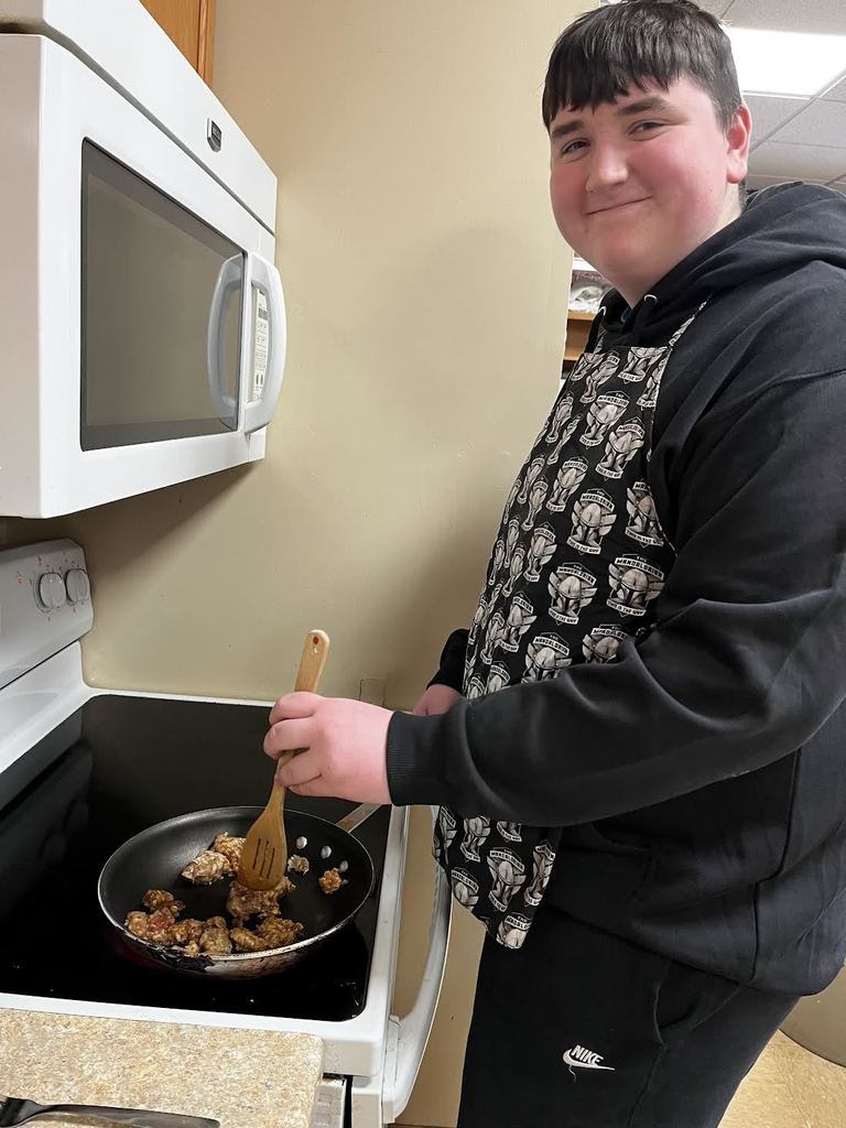 A student sautéing their sausage for a delicious pizza topping!