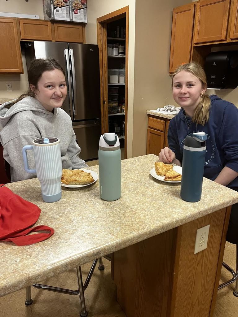 Two students enjoying their pizza!