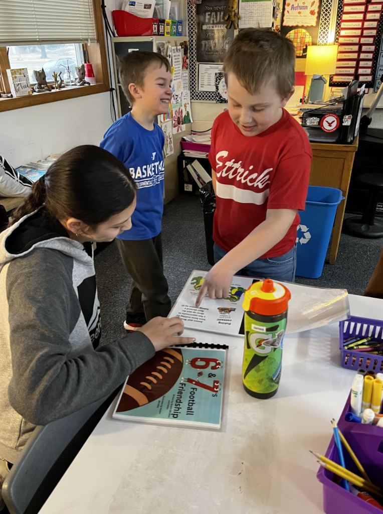 Students read 6 & 7's Football Friendship!