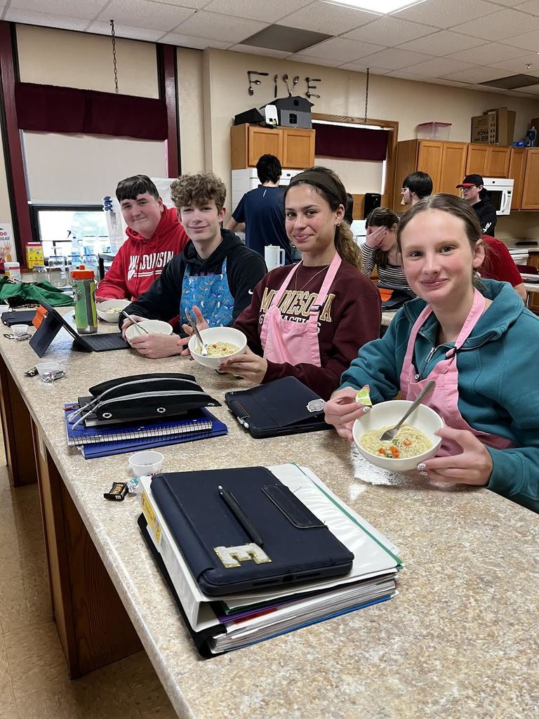 Students showing off their delicious bowls of ramen.