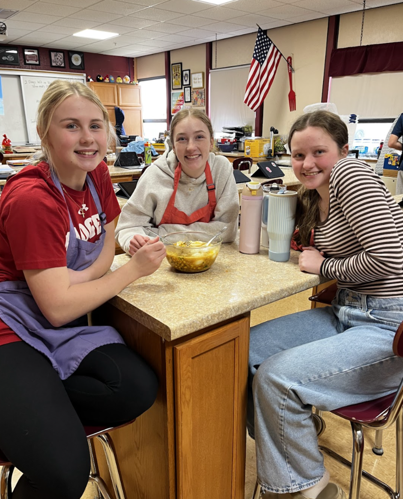 Students showing off their delicious bowls of ramen.