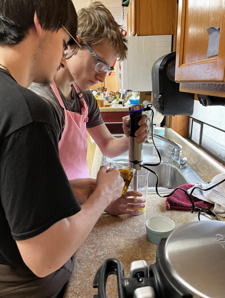Two students preparing mayonnaise from scratch!