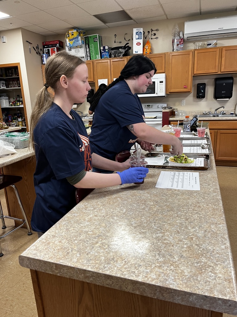 Two students prepare orders for delivery.