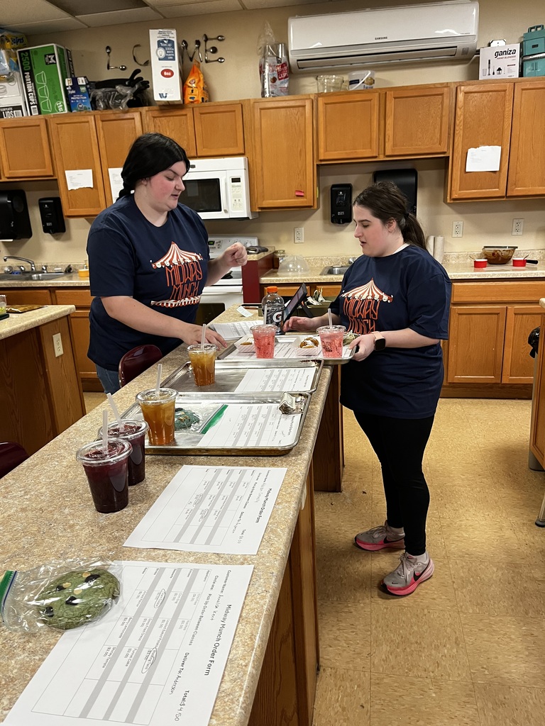 Two students prepare orders for delivery.