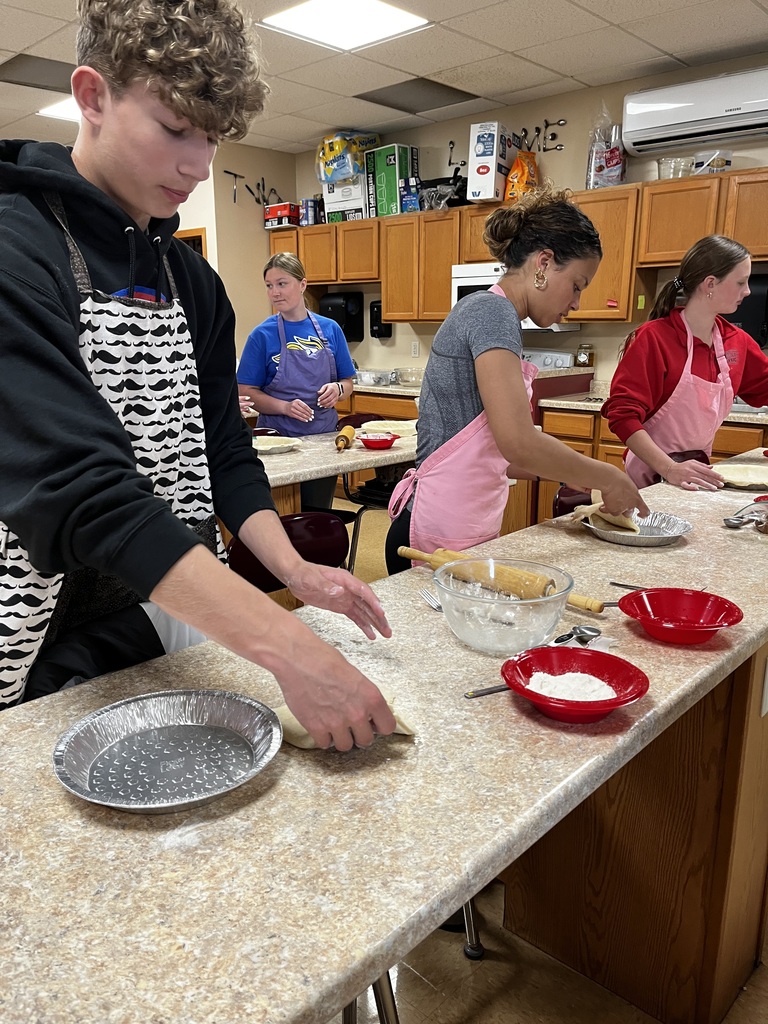 Students place their pie crusts in their pie tins.