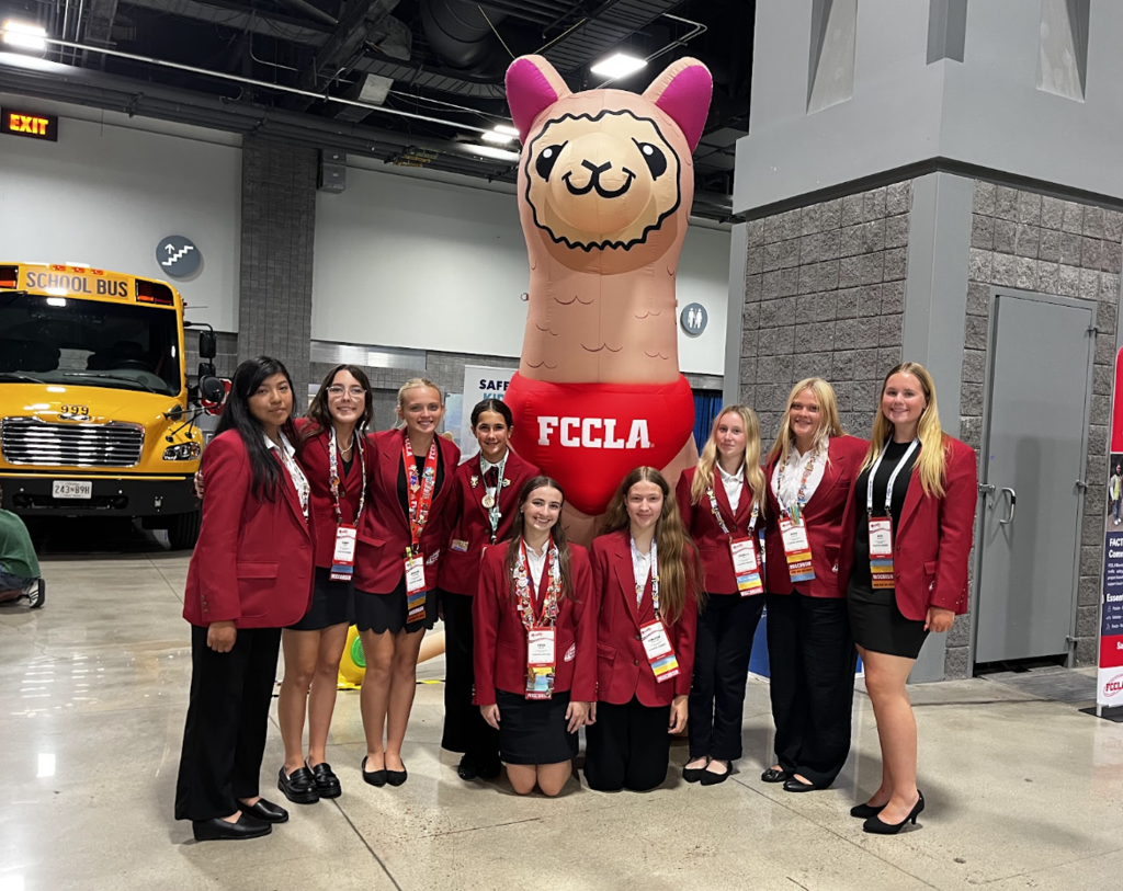 Students pose in front of the FCCLA mascot Rosie!
