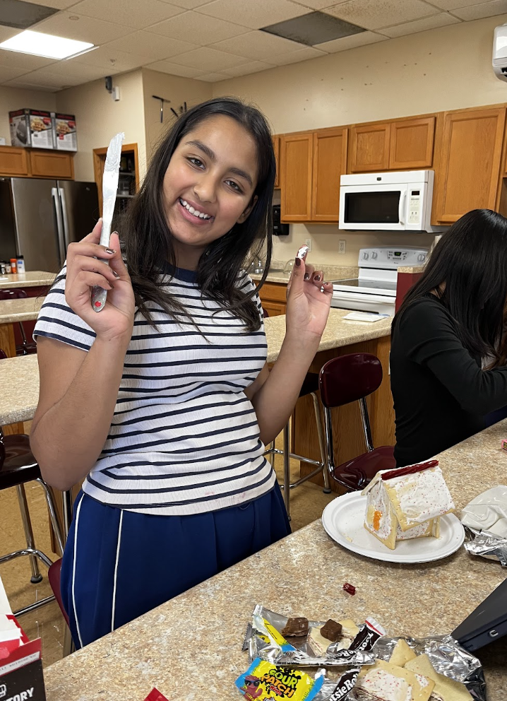 A student build and decorate Poptart houses.