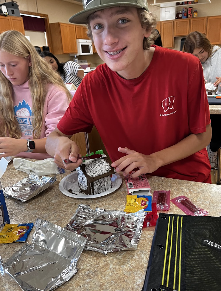 A student build and decorate Poptart houses.