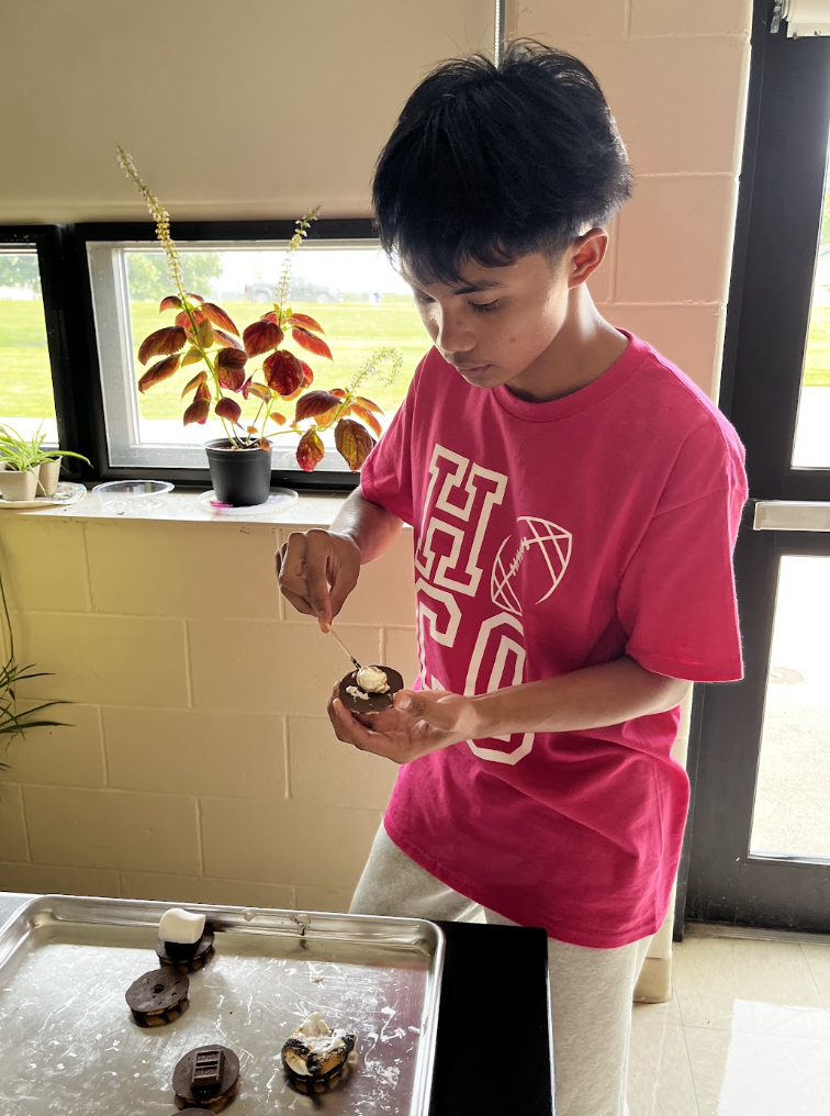 A student assembles his s'more.