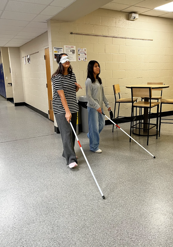 Students use a mobility cane to help them navigate the halls. 