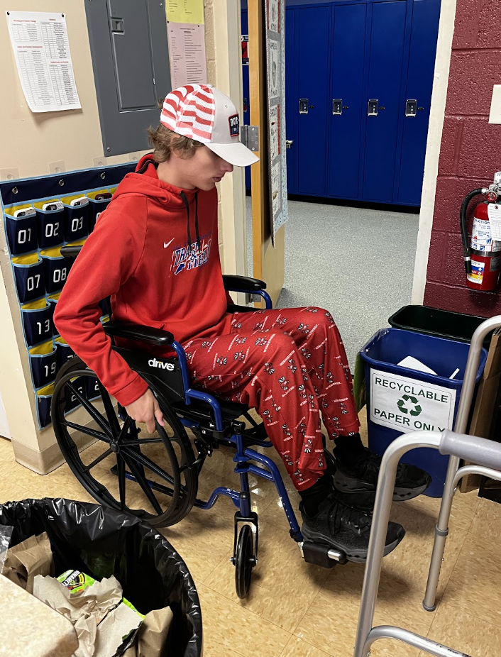 A student navigates the classroom in a wheelchair. 