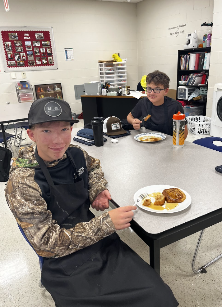 Two students enjoy their French Toast. 
