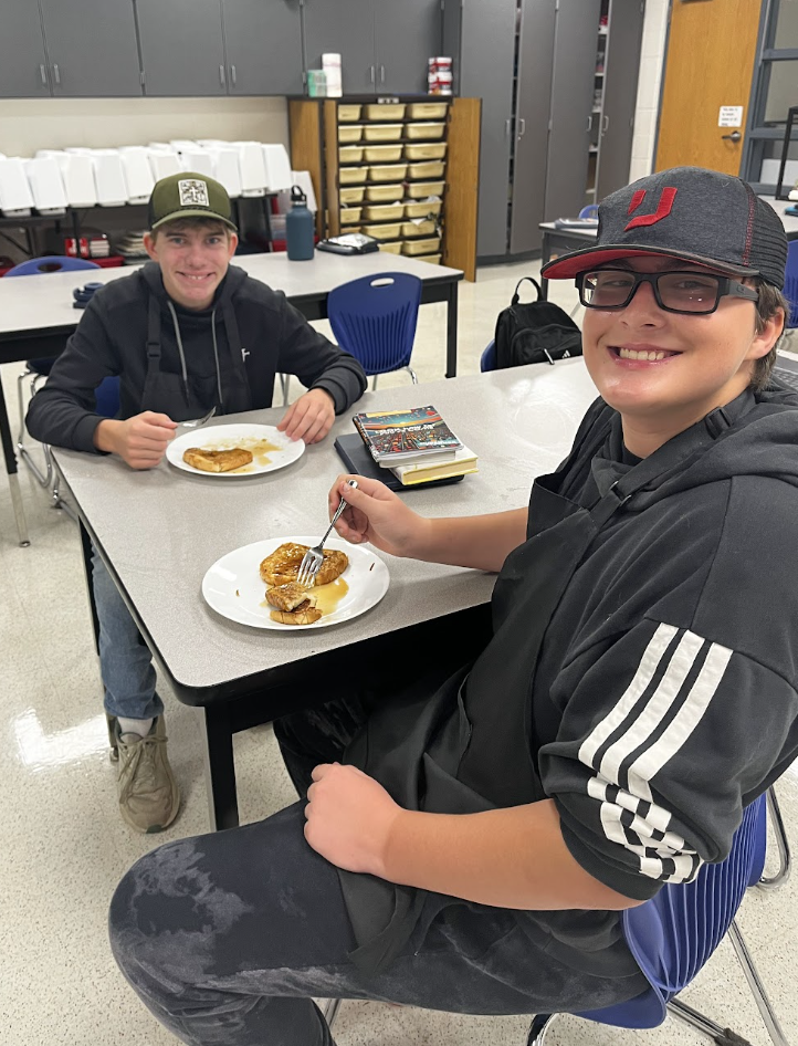 Two students enjoy their French Toast. 
