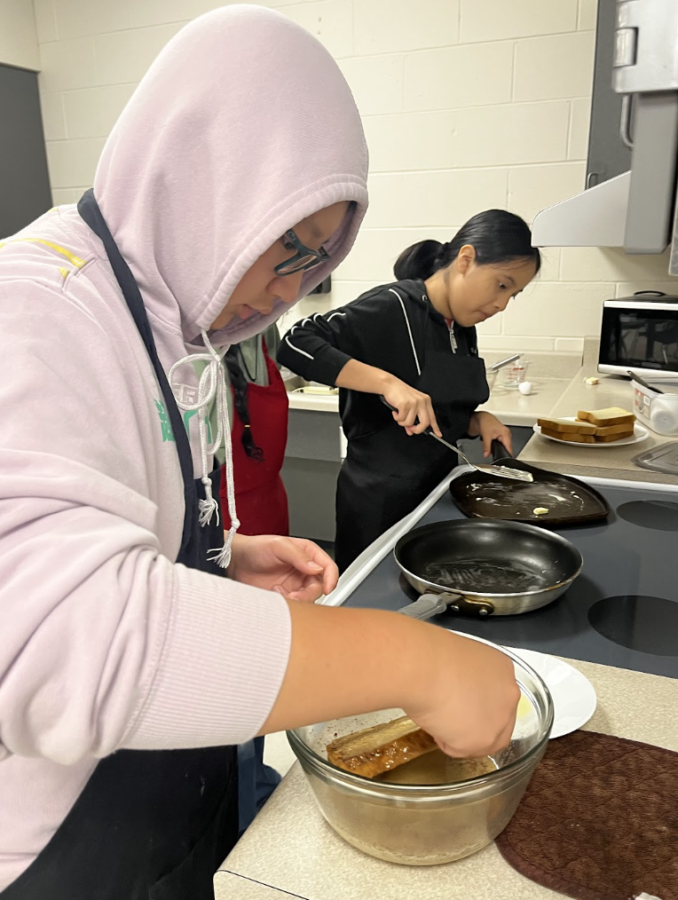Students work together to prepare French Toast. 