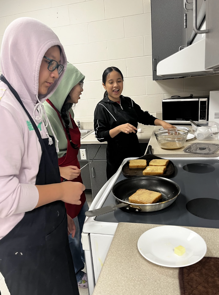 Students work together to prepare French Toast. 