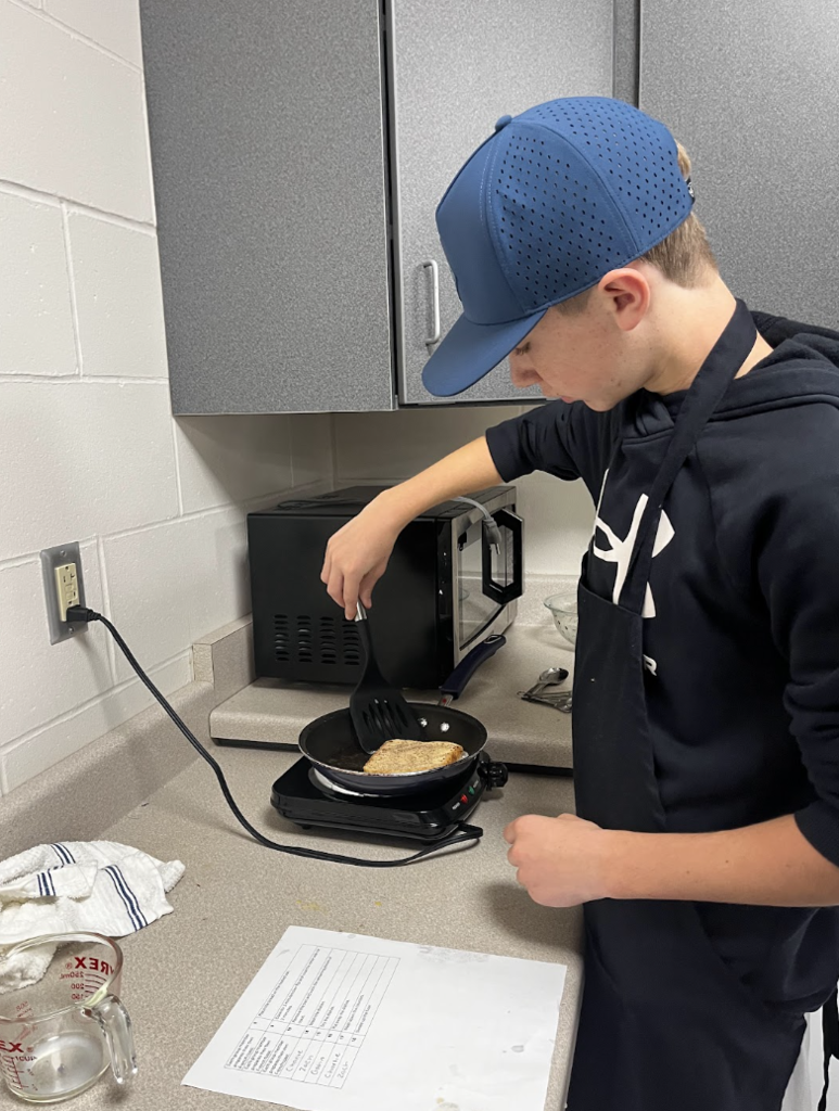 A student flips their French Toast. 