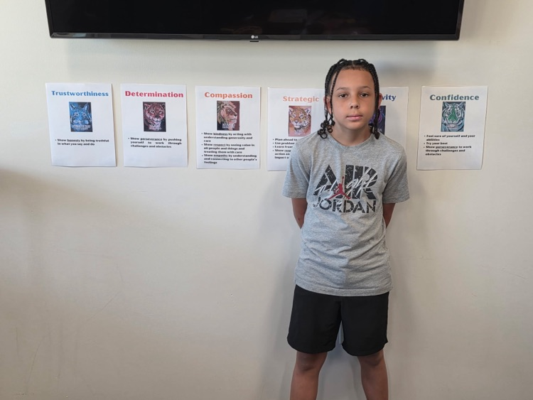 student in front of Wildcat posters