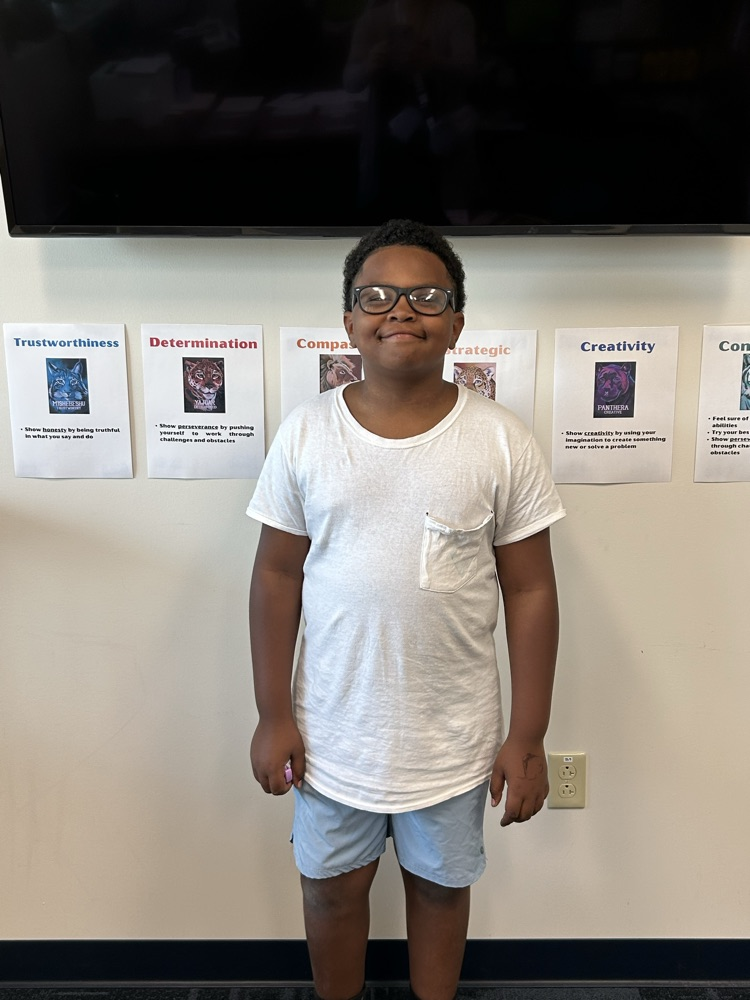 student in front of Wildcat posters