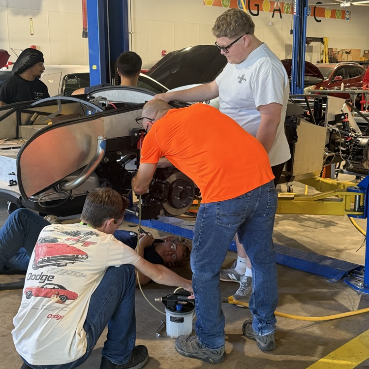 students working on the kit car