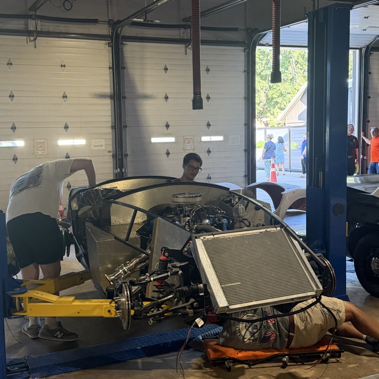 students working on the kit car