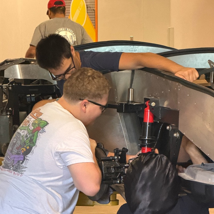 students working on the kit car